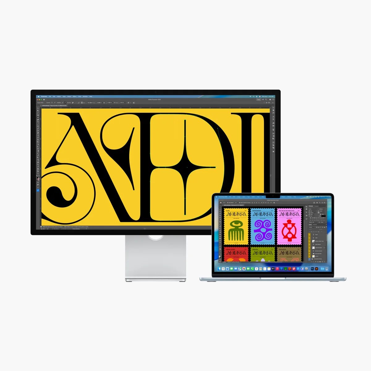 Silver desktop monitor and laptop displaying colorful graphic design software interfaces.