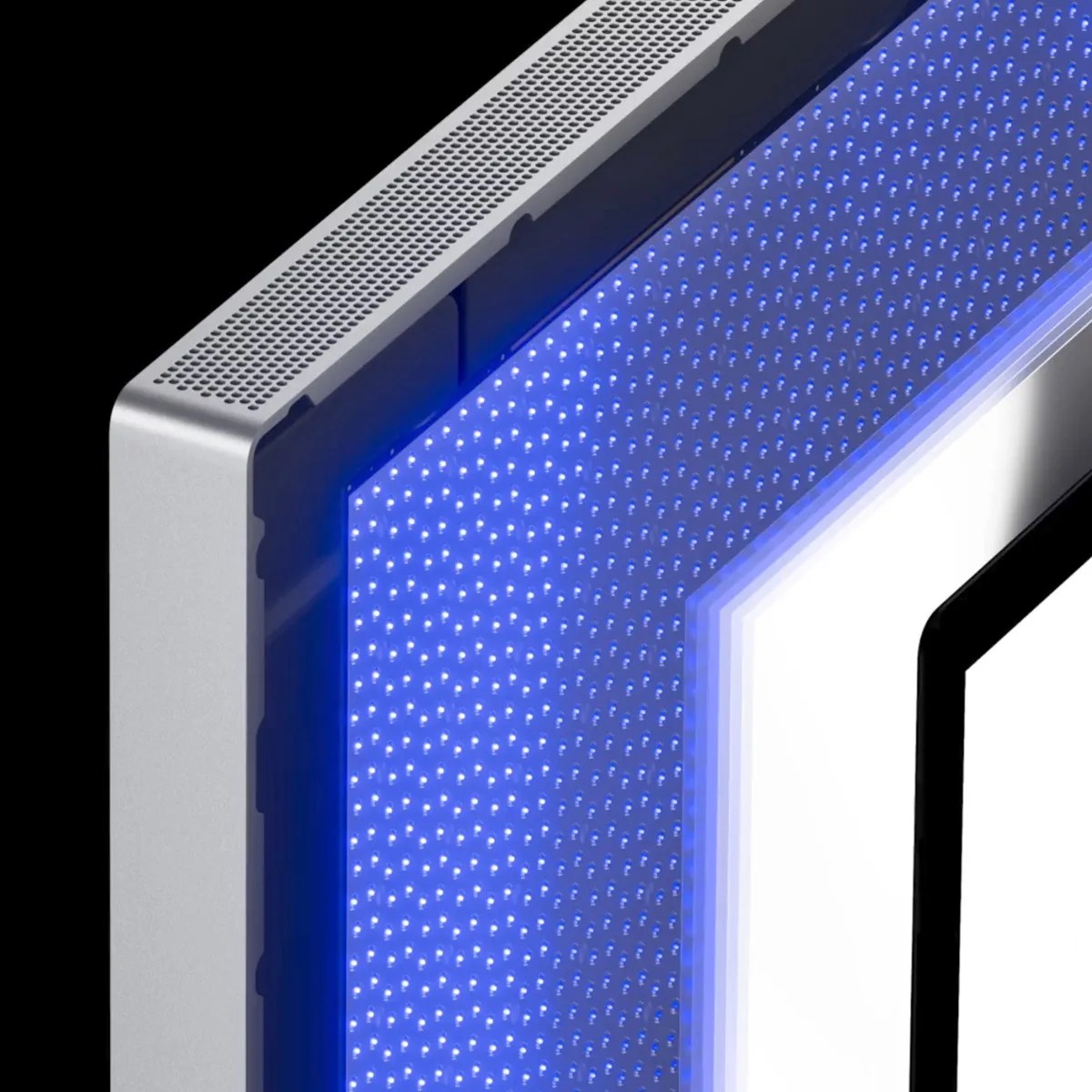 Close-up of a silver electronic device corner with a perforated speaker grille and blue LED lights.