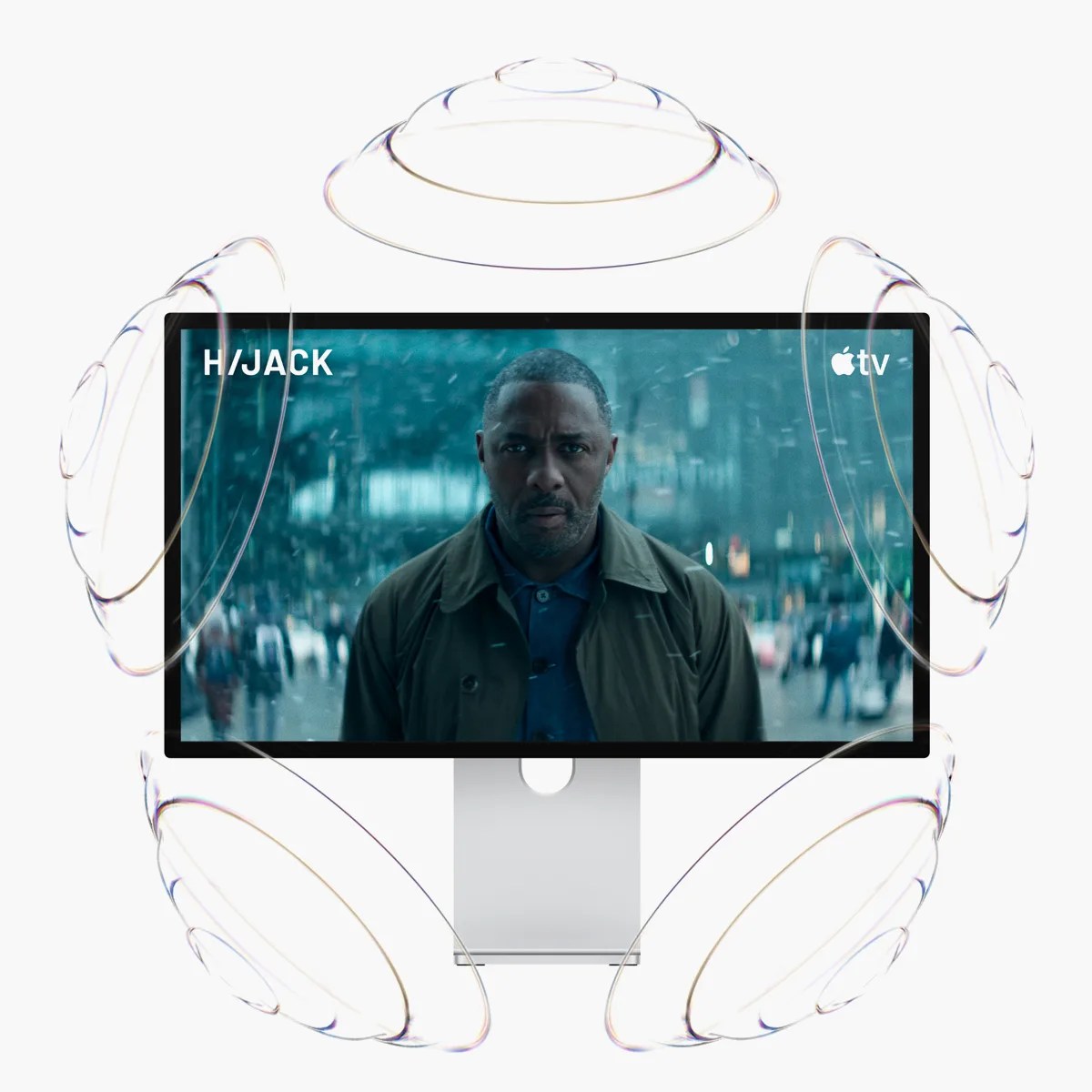 Apple Studio Display showing a scene from H/JACK on Apple TV with transparent sound wave graphics around it.