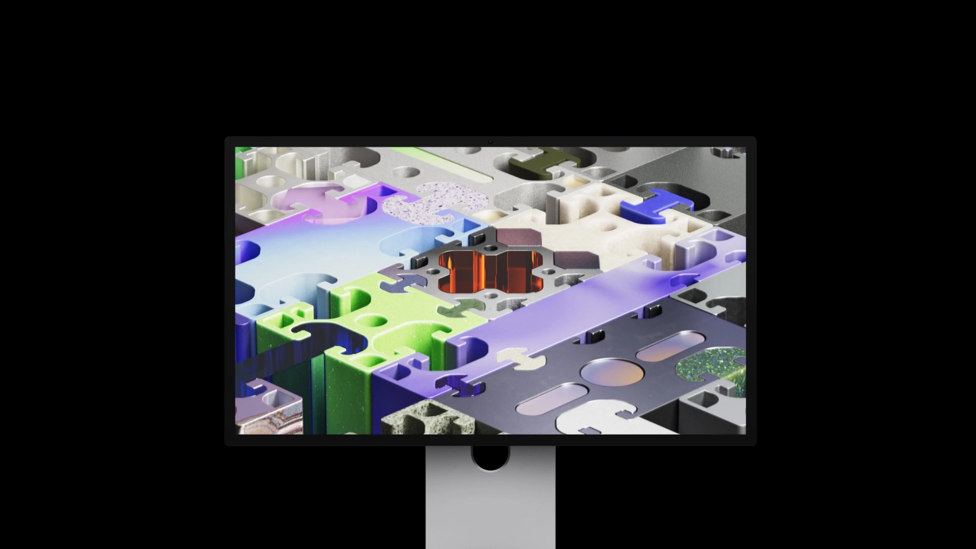 Computer monitor displaying a colorful 3D puzzle with various textured and shaped pieces.