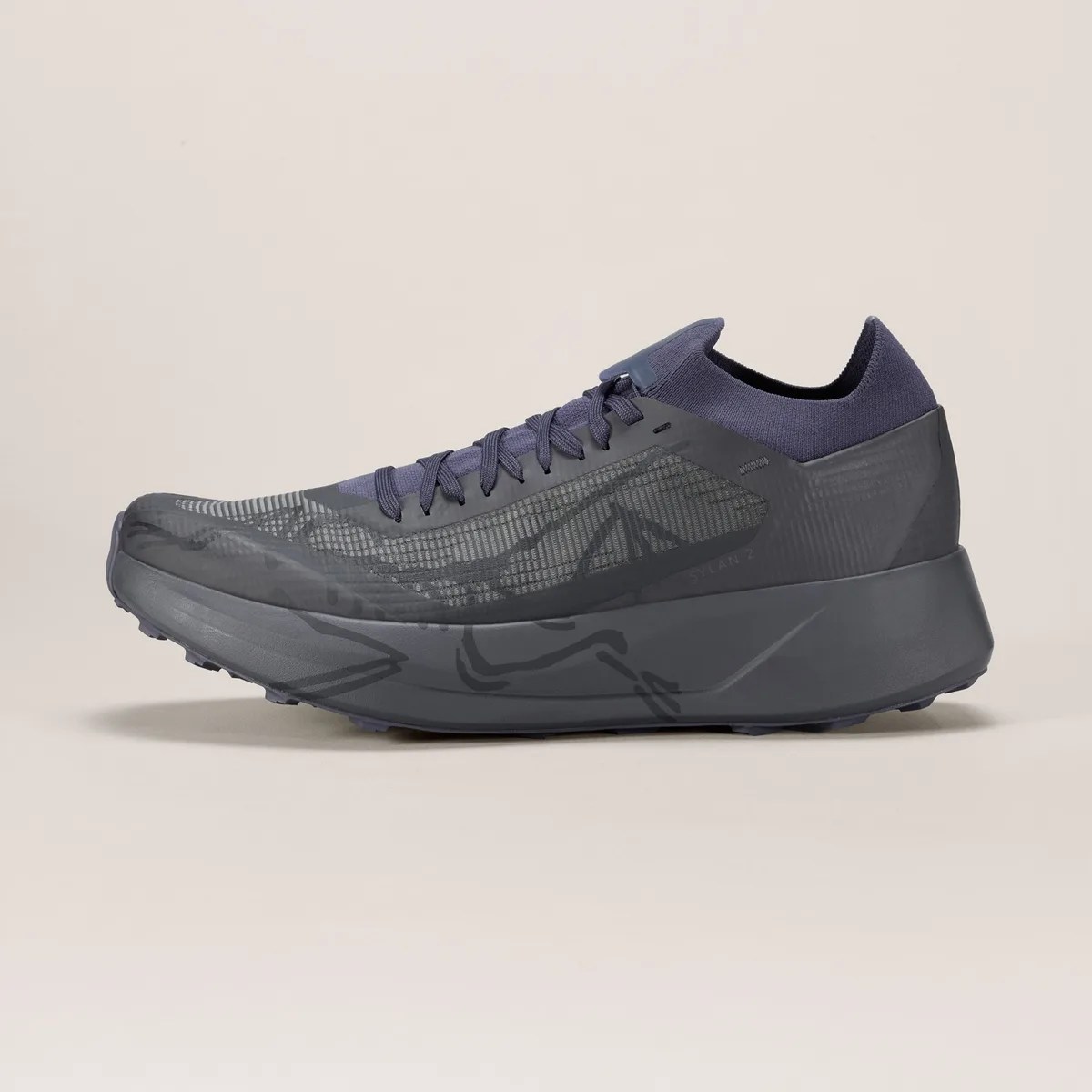Dark gray and navy trail running shoe with thick sole and mesh upper.