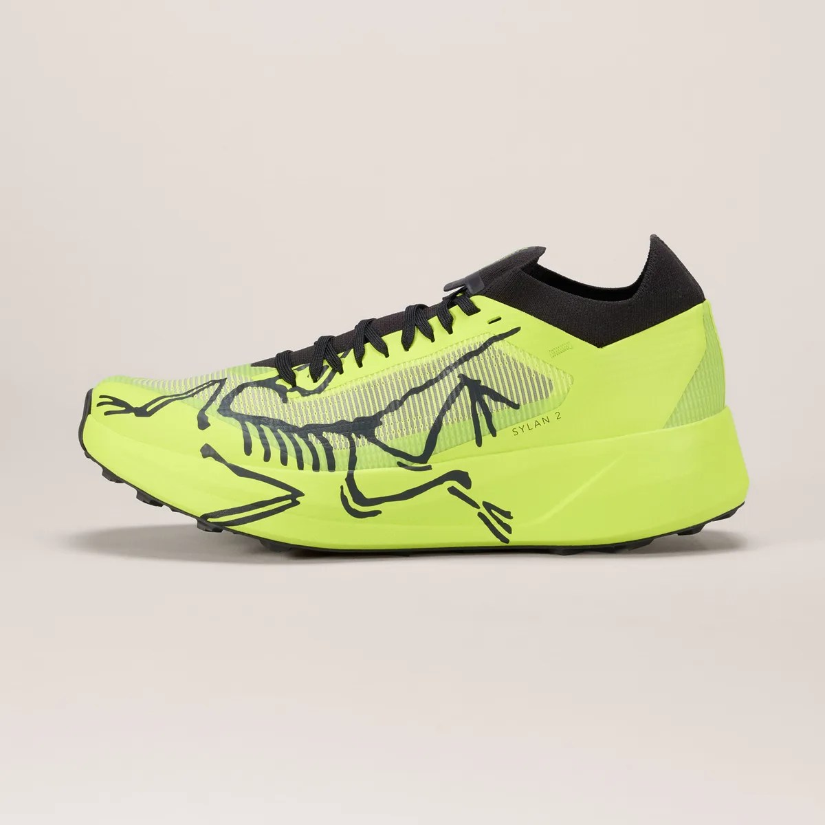 Neon yellow and black running shoe with skeletal frog graphic and black laces.