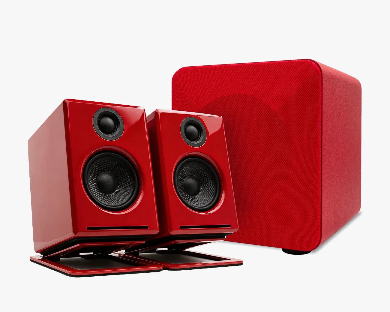Pair of glossy red desktop speakers with black drivers and matching red fabric-covered subwoofer.