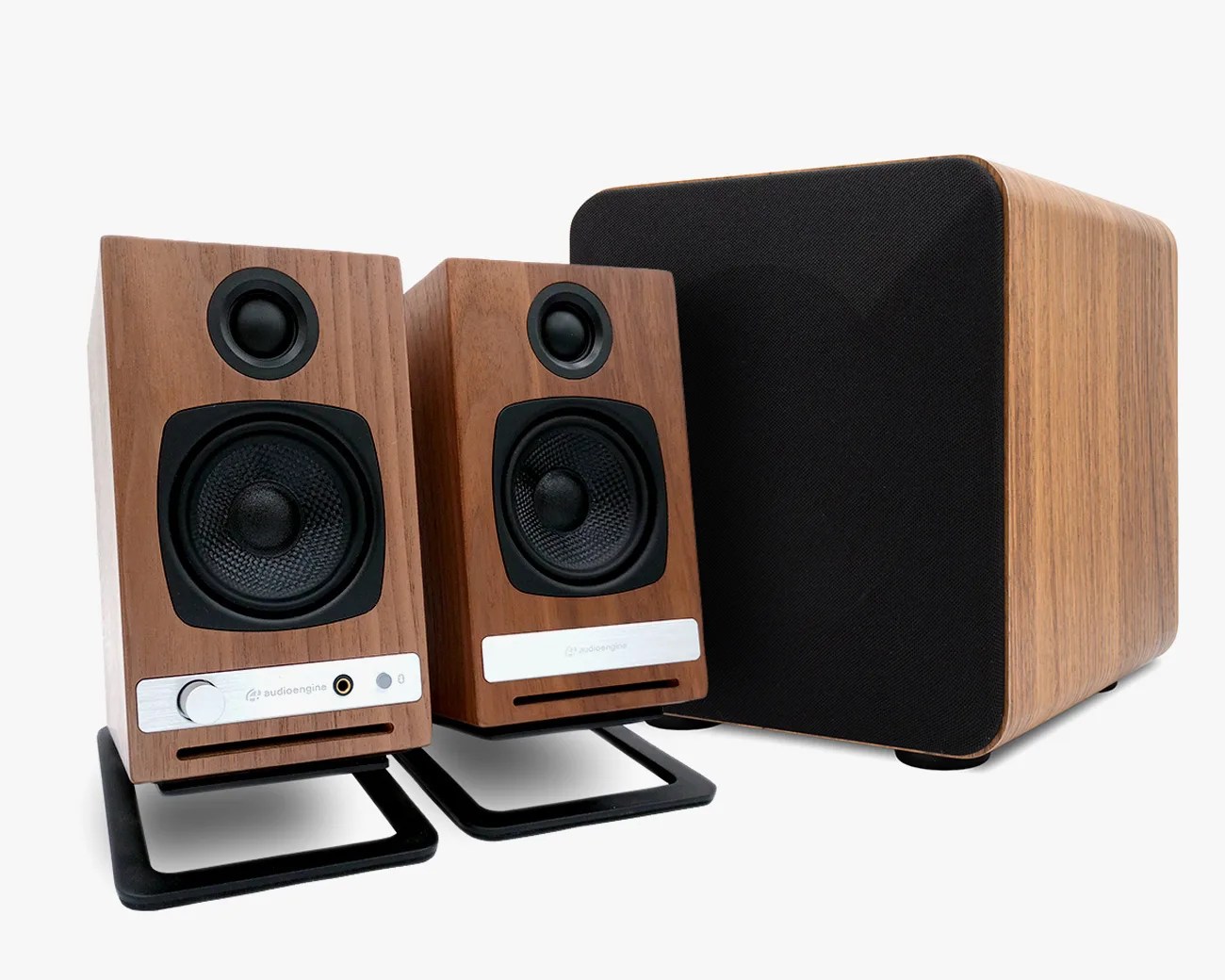 Pair of wooden bookshelf speakers with black speaker cones and a matching wooden subwoofer with black grille.