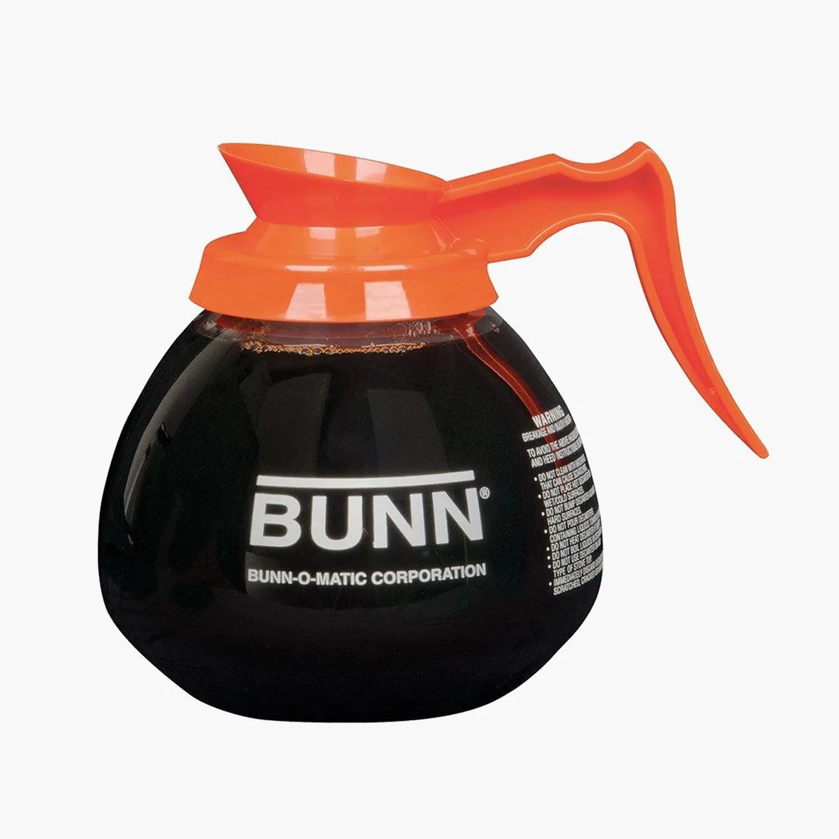Glass coffee carafe with black coffee and an orange plastic handle and lid, labeled "BUNN.