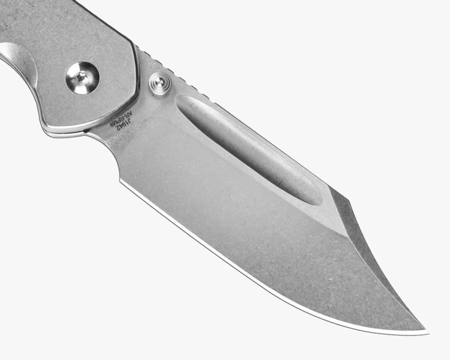 Close-up of a stonewashed stainless steel folding knife blade with a thumb stud and elongated oval cutout.