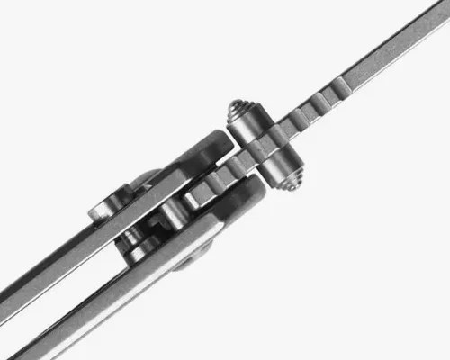 Silver metal folding knife with a thin, pointed blade and a clip on the handle.