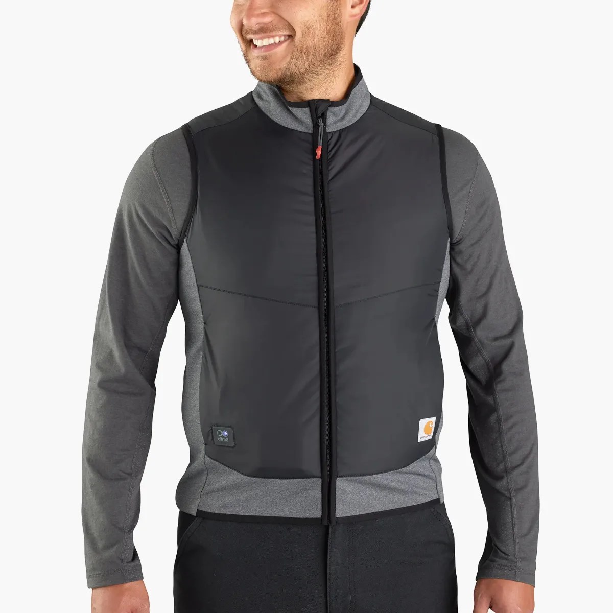 Black and gray zip-up insulated vest worn over a gray long-sleeve shirt.
