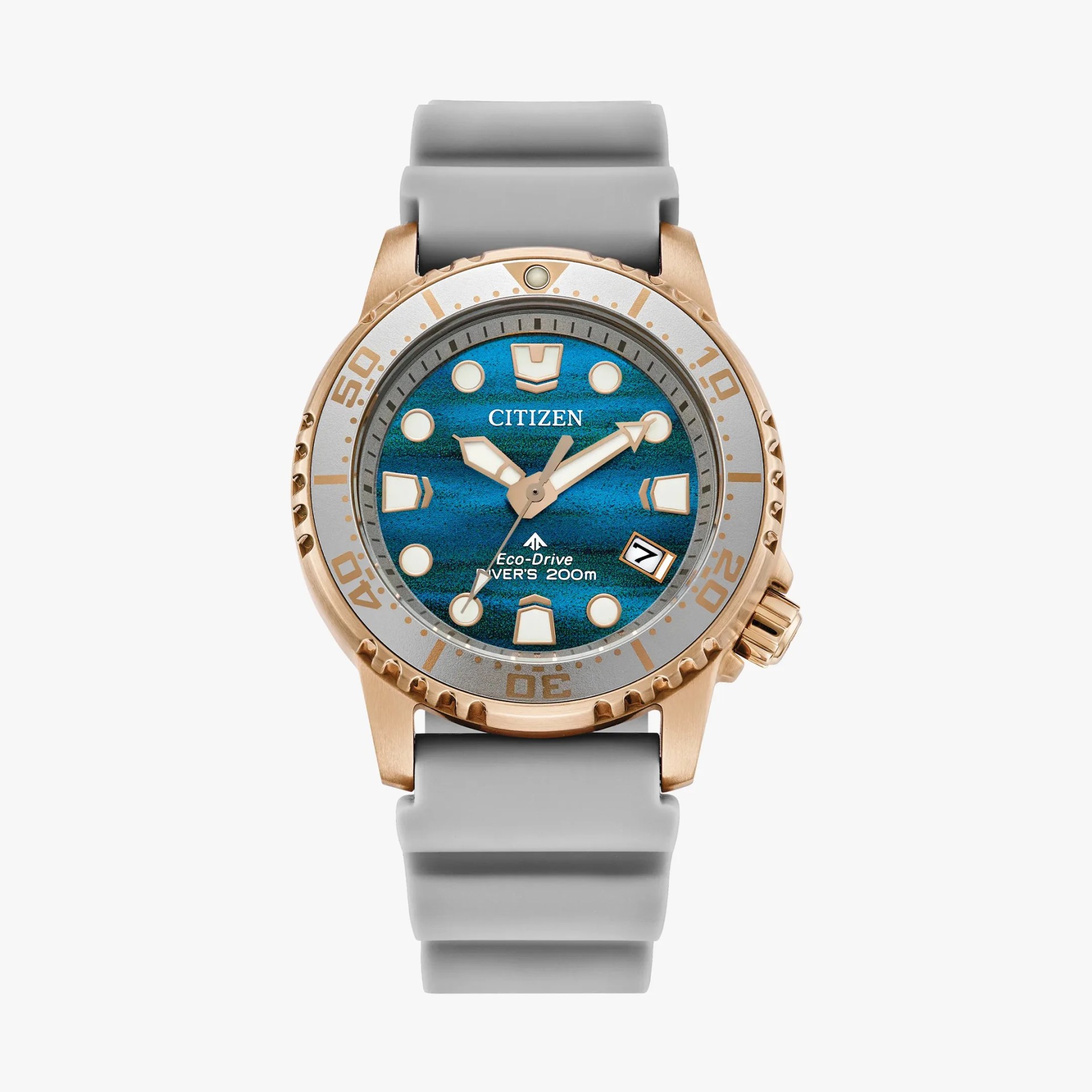Diver's watch with blue textured dial, rose gold bezel, and light gray silicone strap.