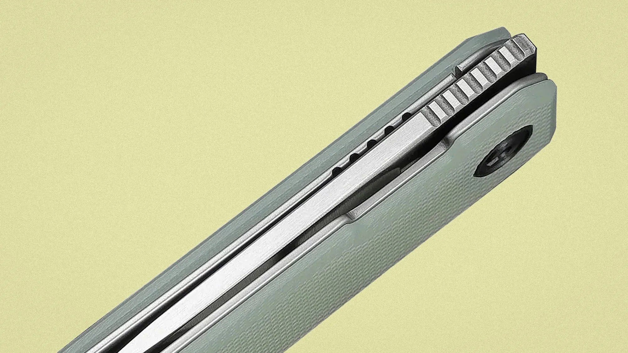 Close-up of a folded gray pocket knife with textured handle and visible metal blade spine.