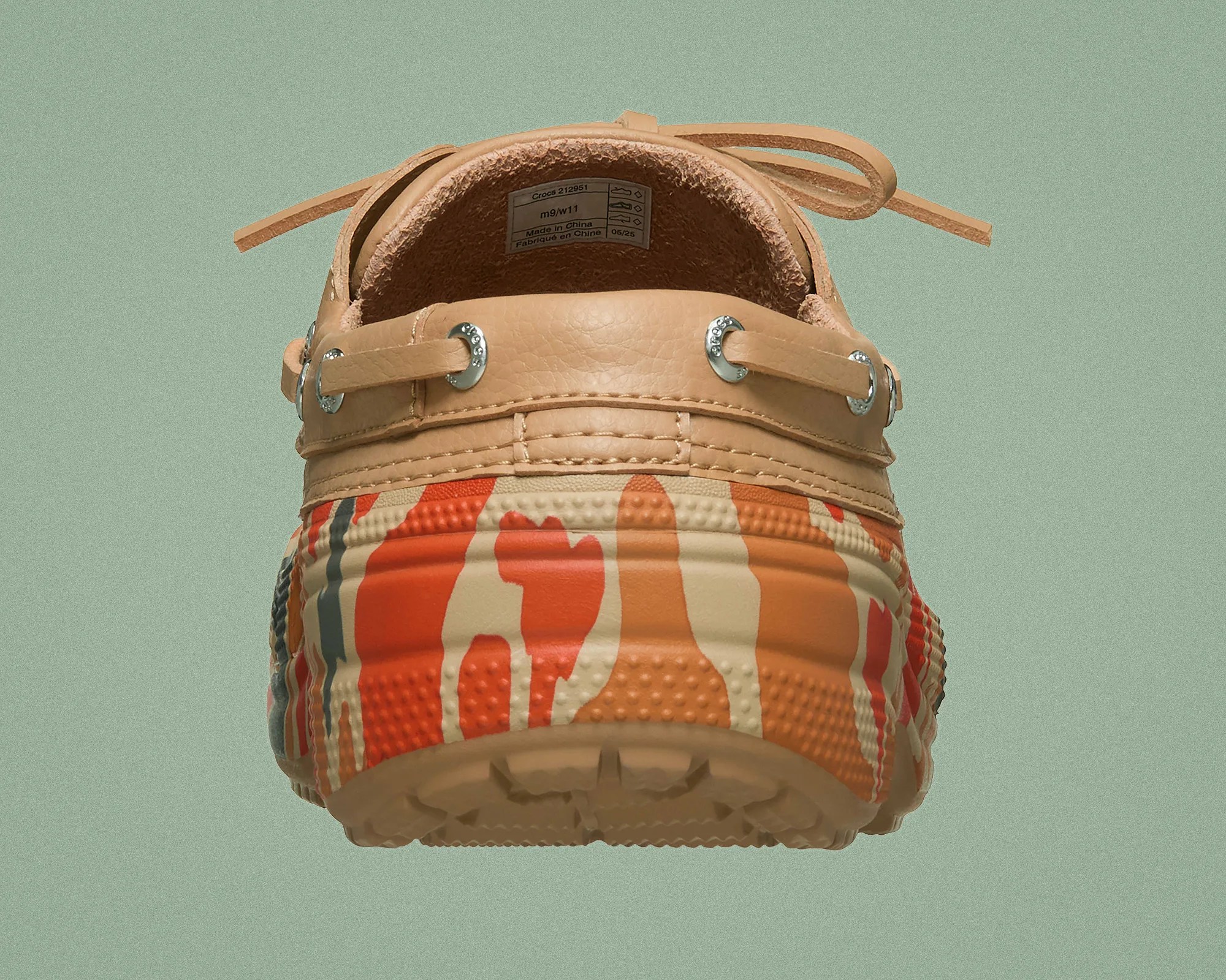 Tan leather and multicolor camo-patterned Crocs shoe viewed from the back.