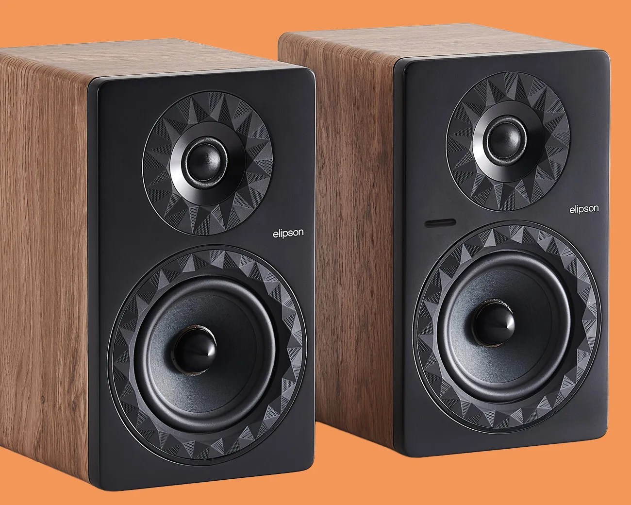 Pair of Elipson bookshelf speakers with wood veneer sides and black front panels featuring geometric-patterned speaker surrounds.