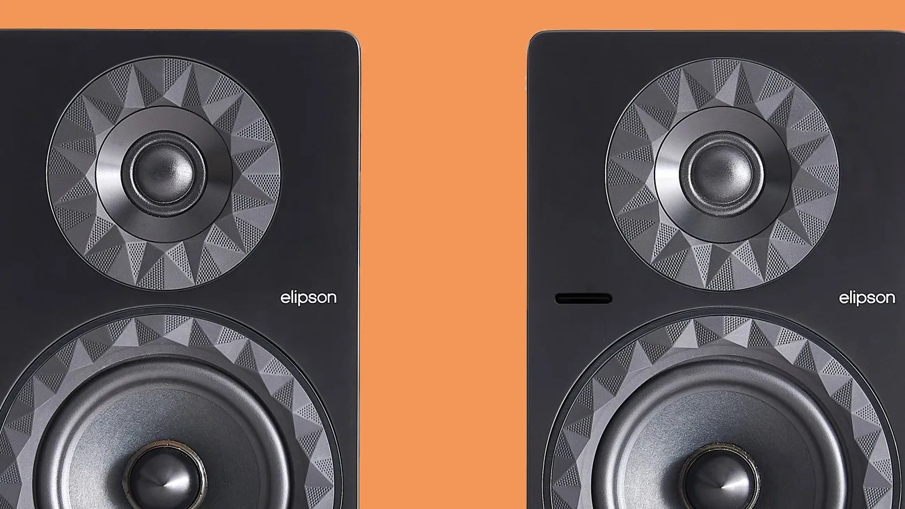 Pair of black Elipson speakers with geometric patterned speaker cones on an orange background.