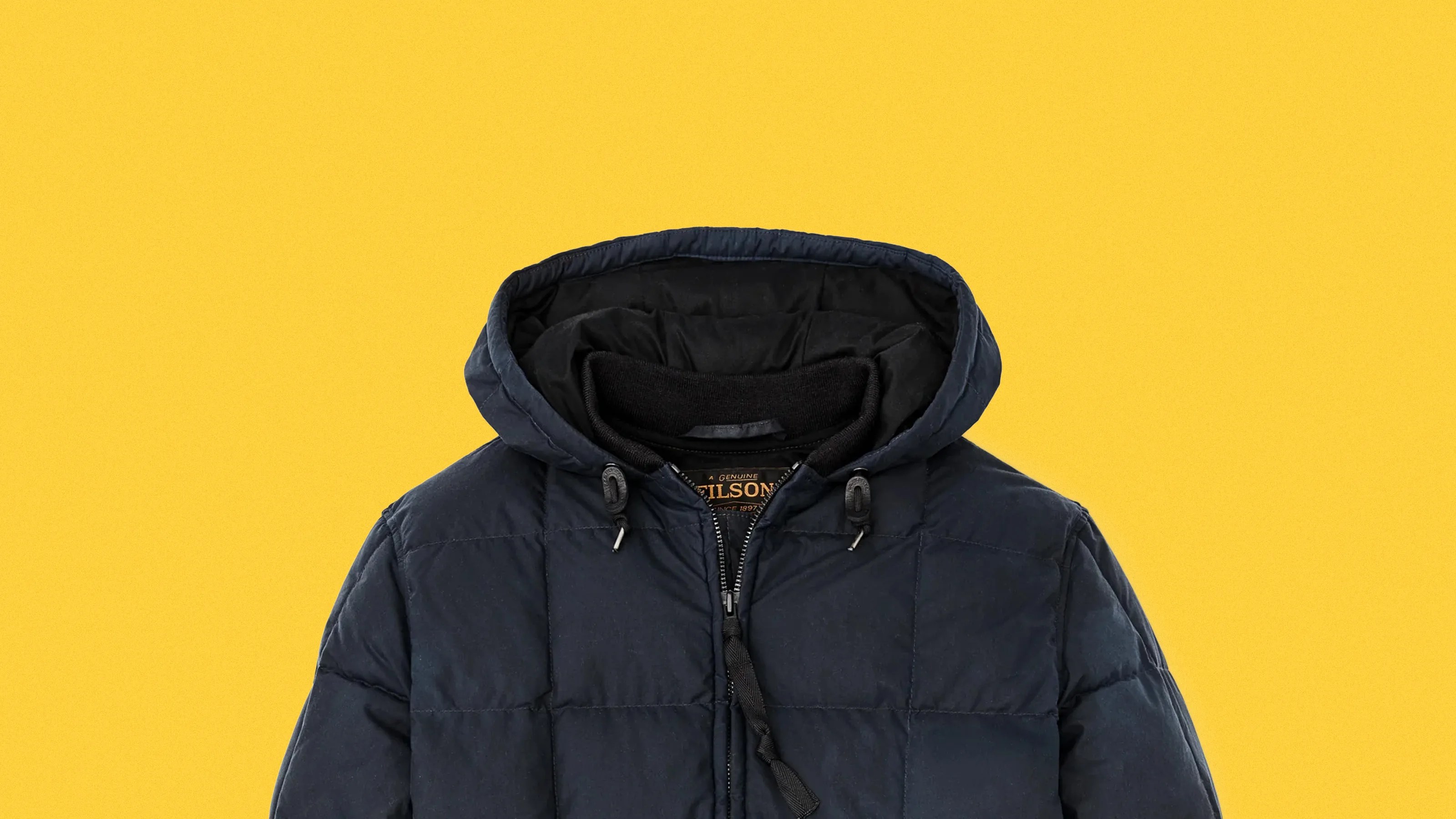 Navy blue quilted hooded jacket with black inner lining and zipper closure on a yellow background.