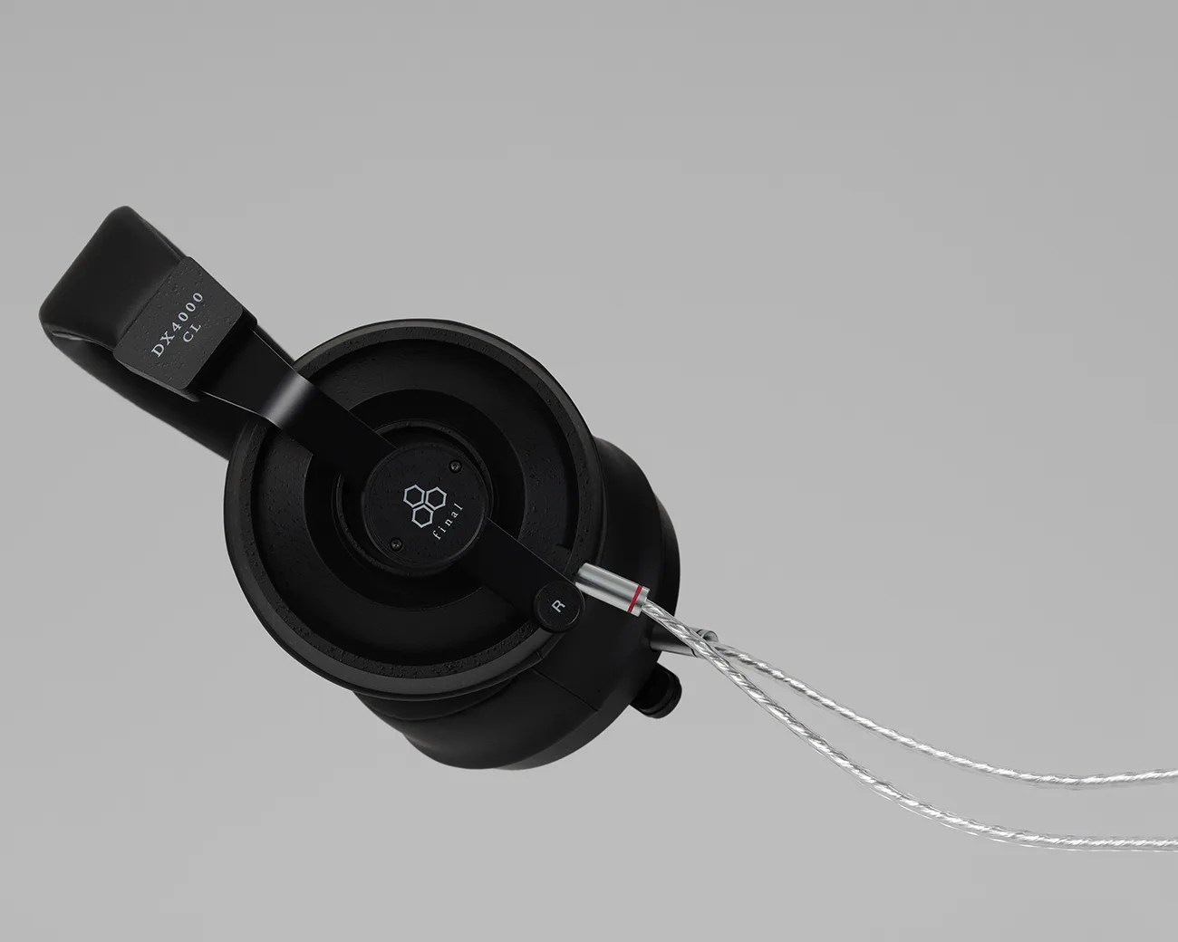 Black Final DX4000 CL over-ear headphone with braided silver cable on a gray background.