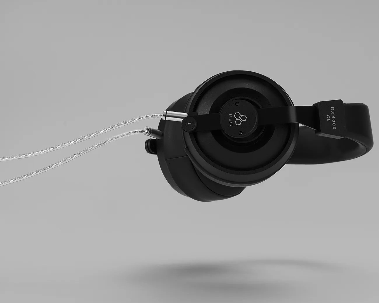 Black Final DX4000 CL over-ear headphones with braided silver cable on a gray background.