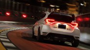 White sporty hatchback car with illuminated taillights driving on a curved racetrack at night.
