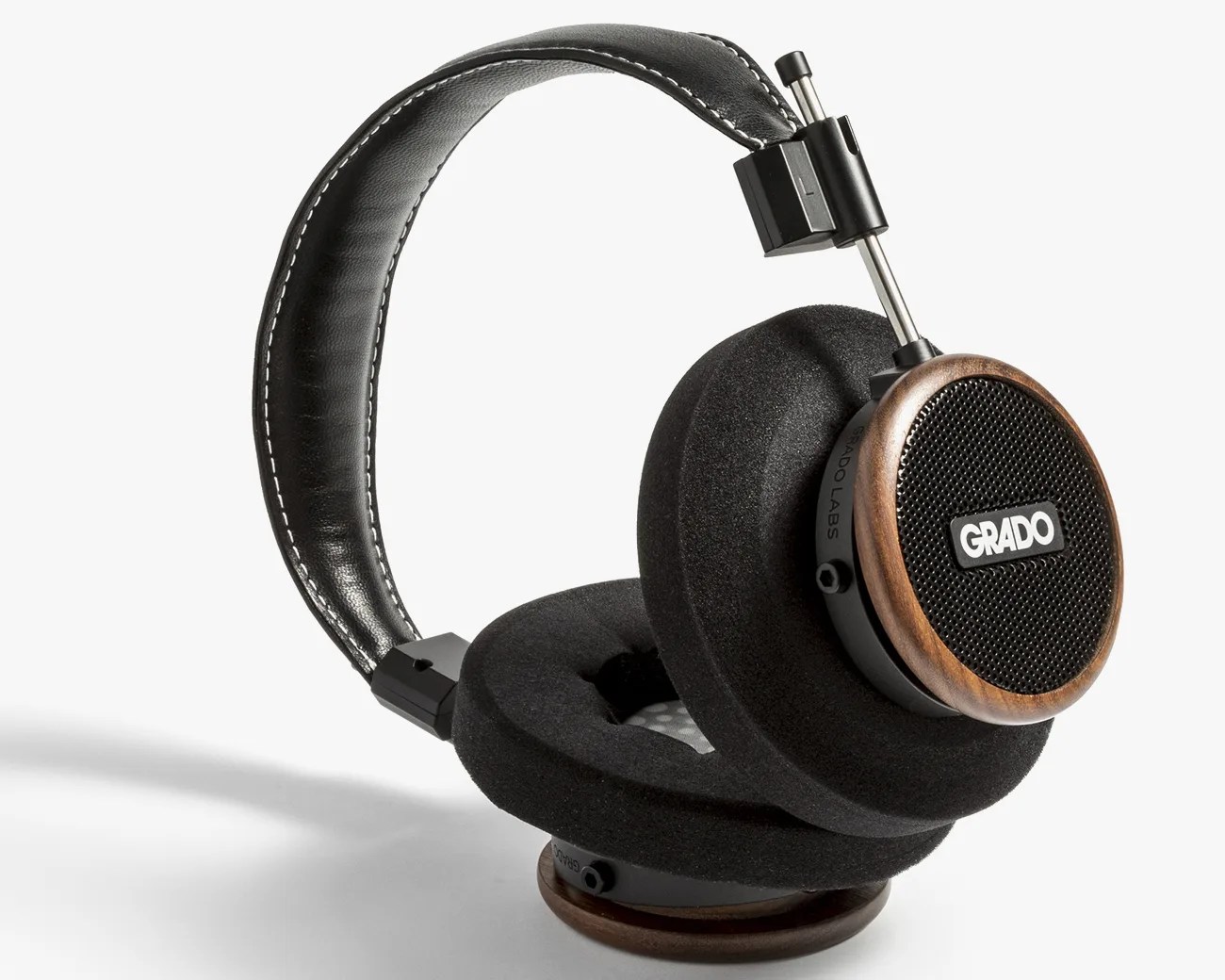 Over-ear Grado headphones with black foam ear pads, wooden ear cups, and a black leather headband.