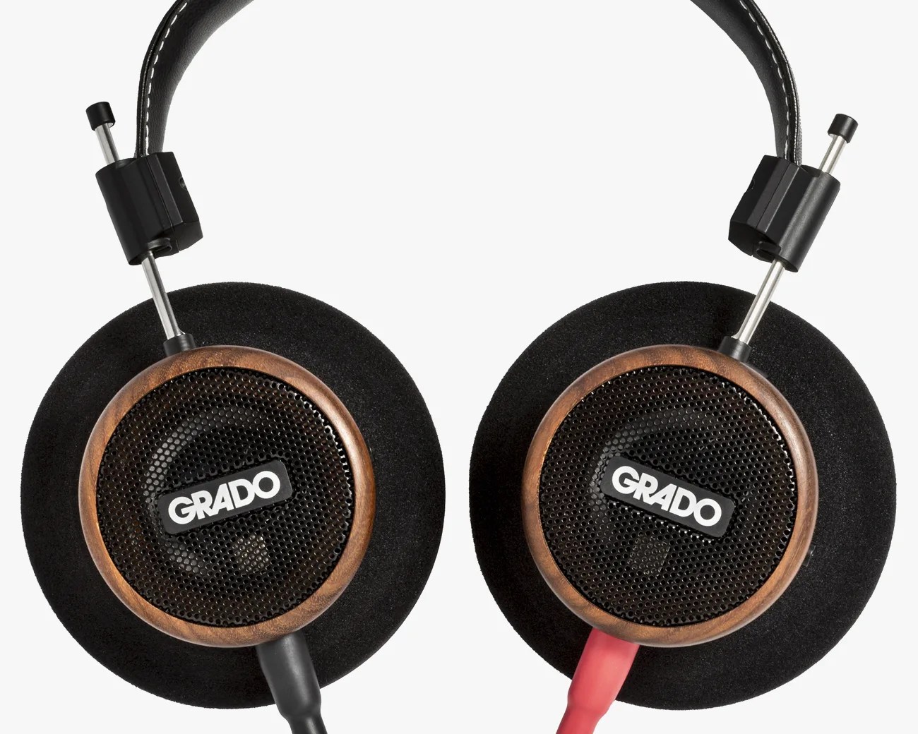 Over-ear Grado headphones with wooden ear cups, black foam padding, and red and black cables.