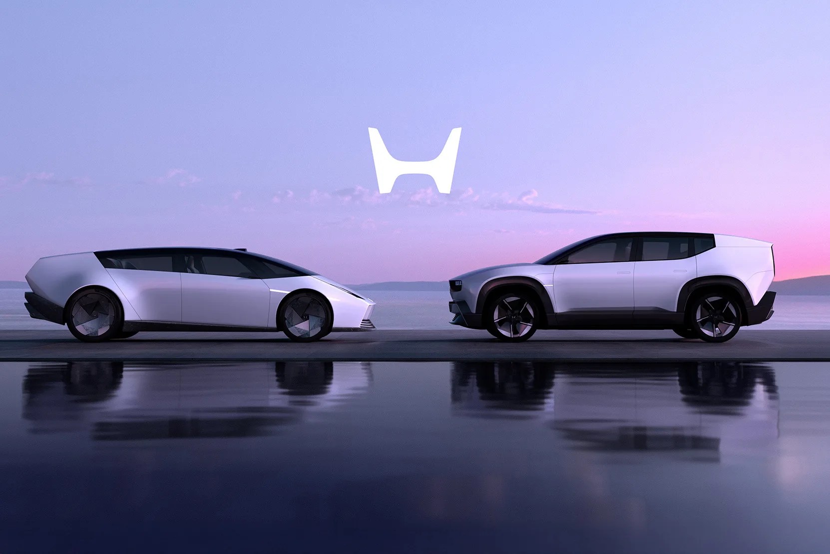 Two silver futuristic electric cars, a sedan and an SUV, parked side by side with a large white Honda logo above them.