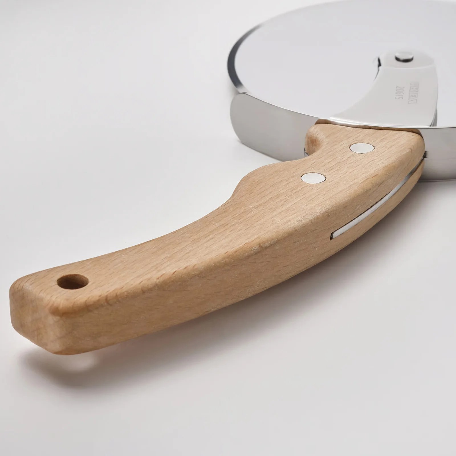 Pizza cutter with a round stainless steel blade and a light wooden handle with two metal rivets.