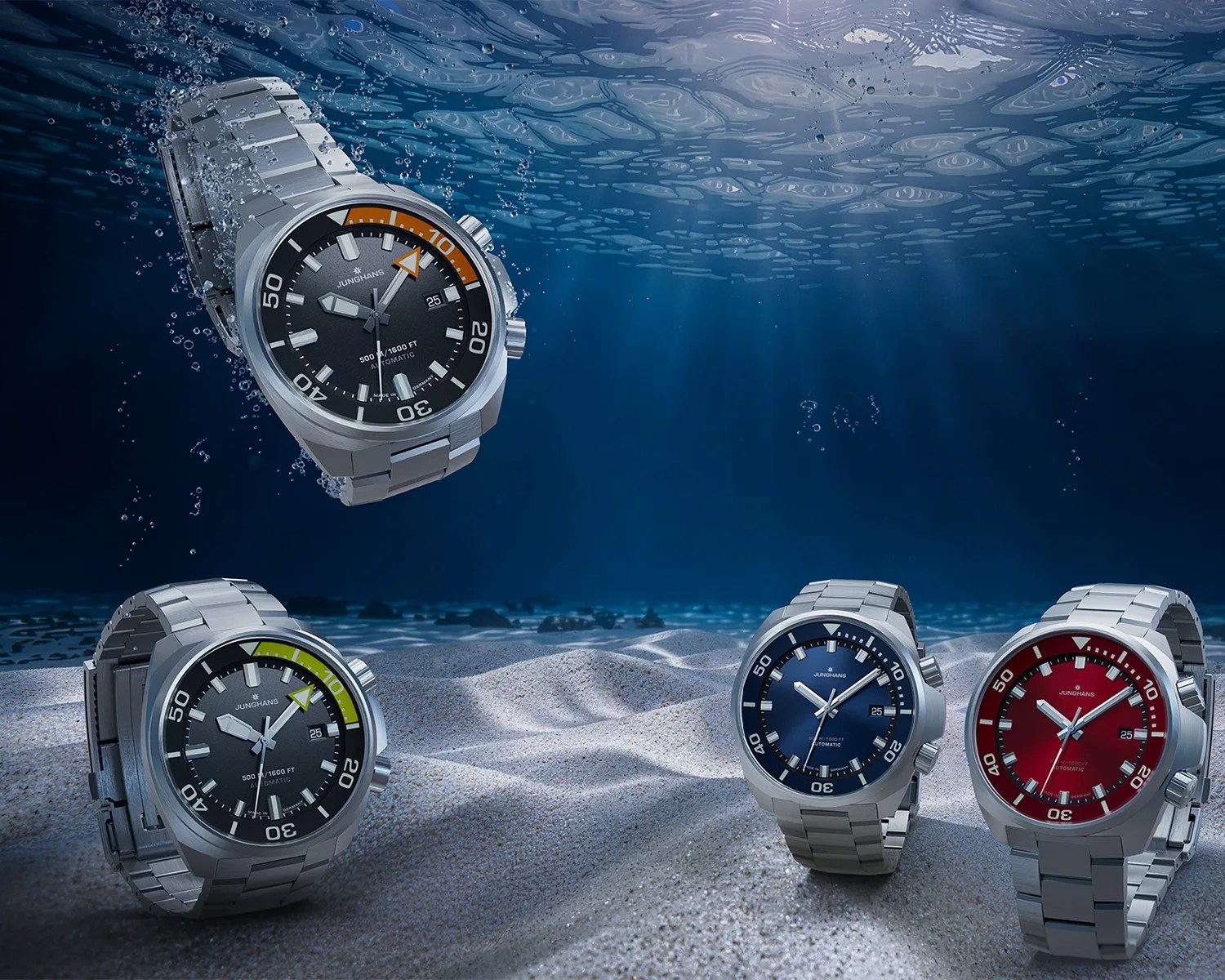 Four stainless steel Junghans dive watches with black, blue, red, and black dials with colored bezel segments underwater on sandy ocean floor.