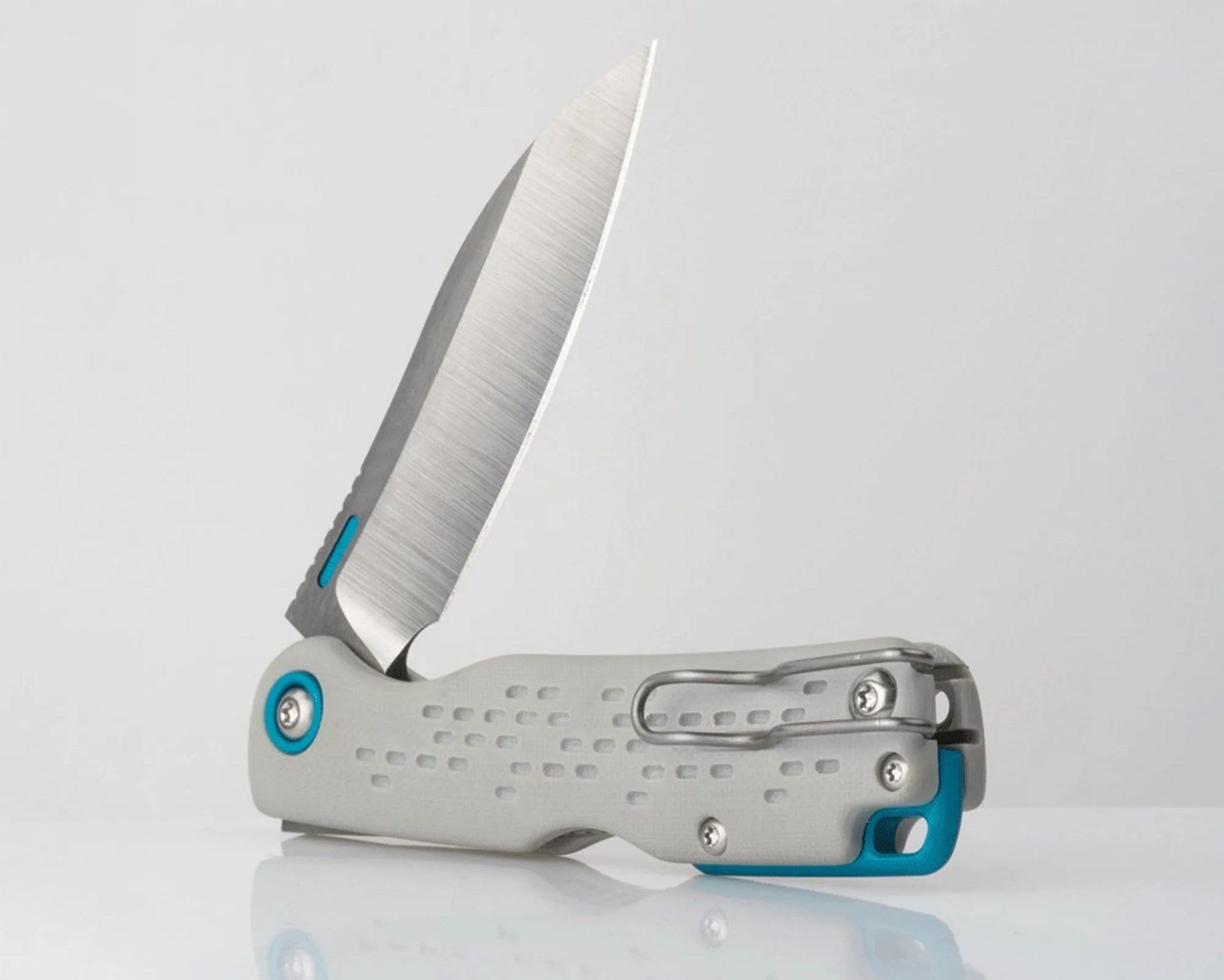Folding pocket knife with a partially serrated stainless steel blade and a textured light gray handle with blue accents.