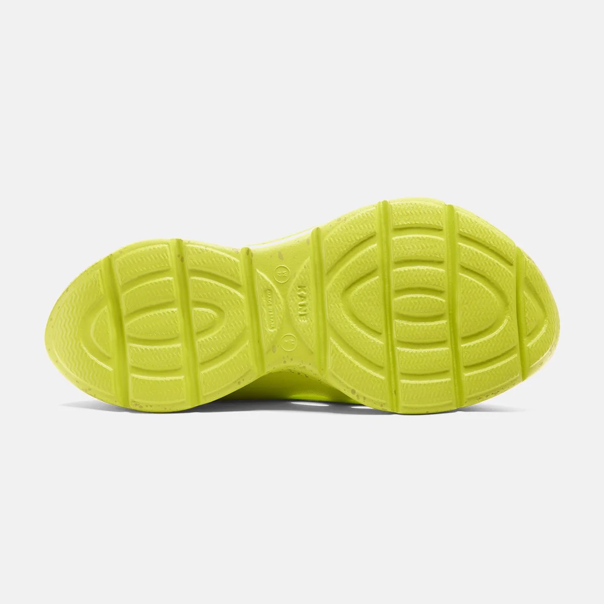 Bright yellow-green rubber shoe sole with textured grip pattern and horizontal grooves.
