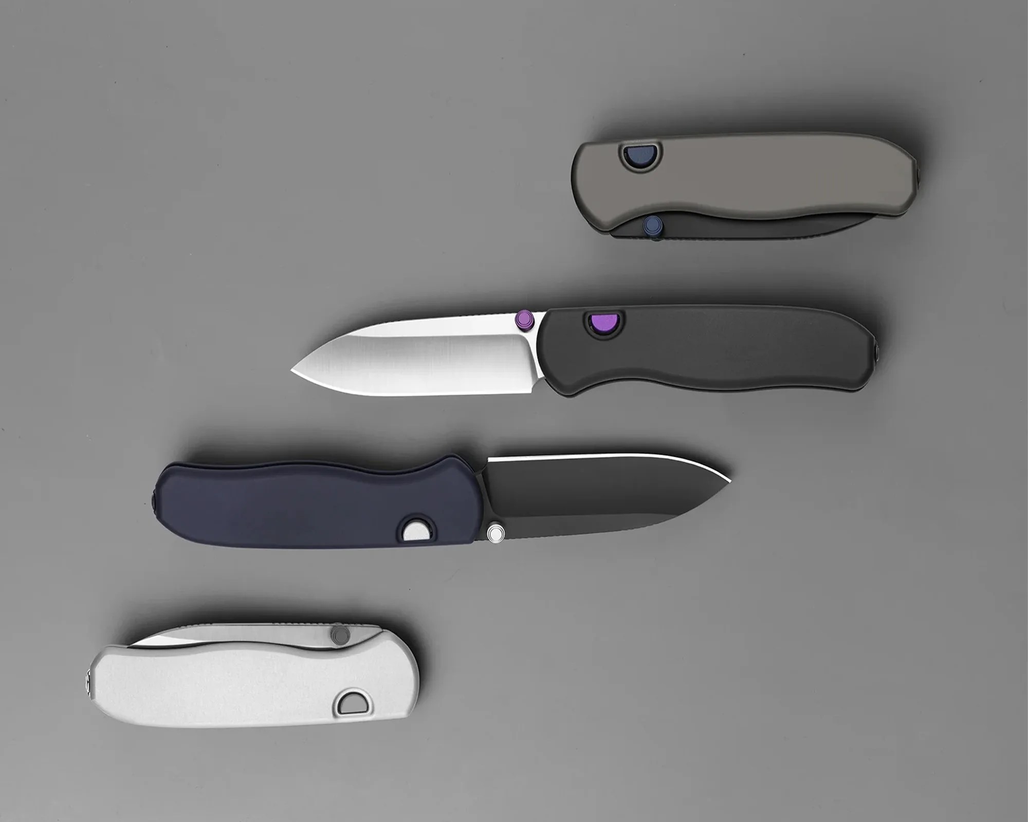 Four folding knives on a gray surface, two open with silver and black blades, two closed with gray and silver handles.