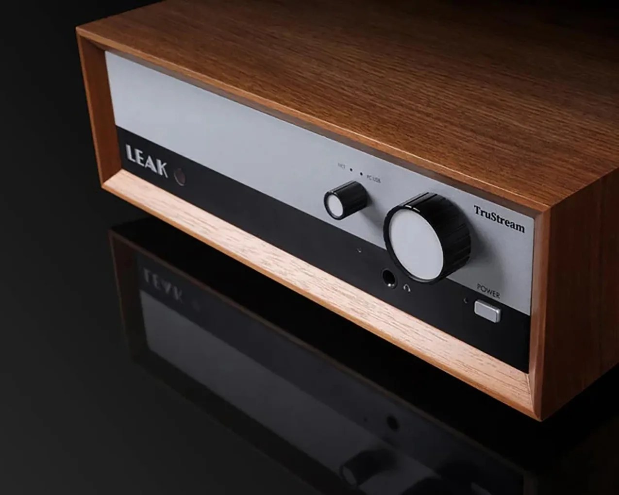 Wooden-cased Leak TruStream audio amplifier with black and silver front panel and control knobs.
