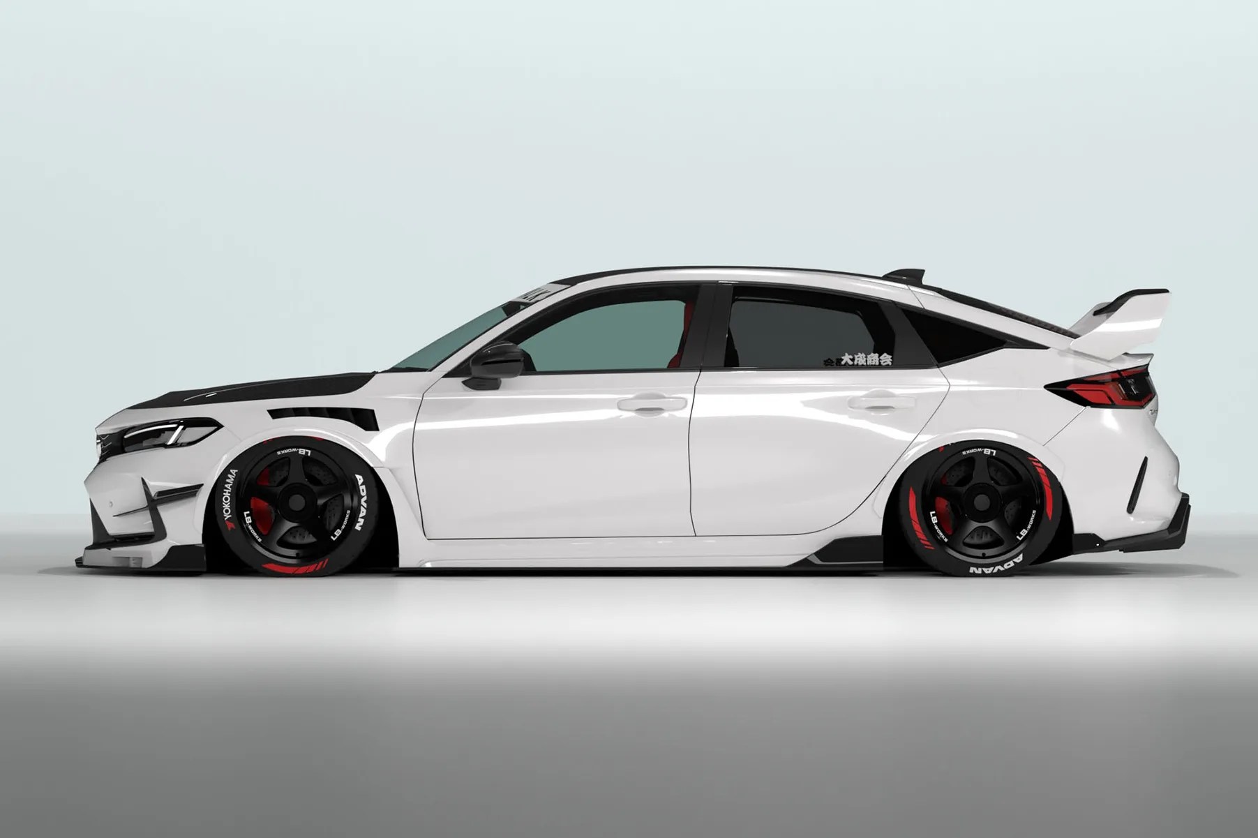 White lowered hatchback car with black and red racing wheels and a large rear spoiler.