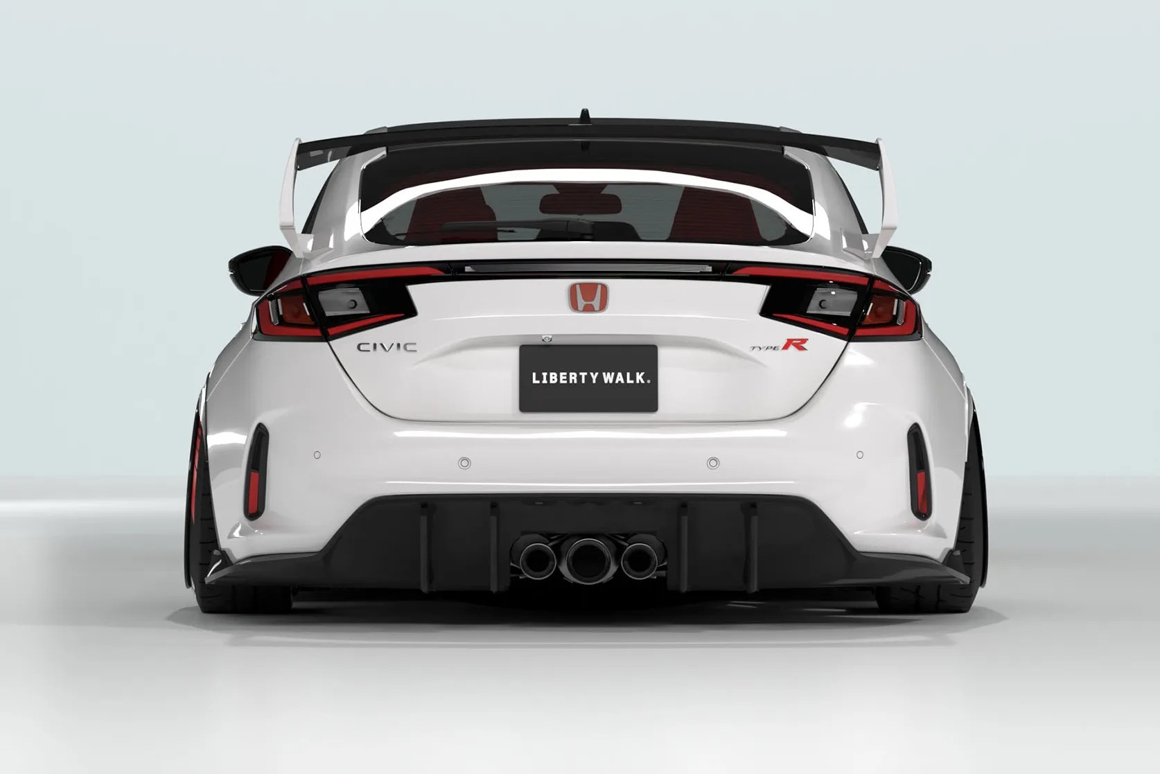 White Honda Civic Type R with widebody kit, large rear wing, and triple exhaust pipes viewed from the rear.