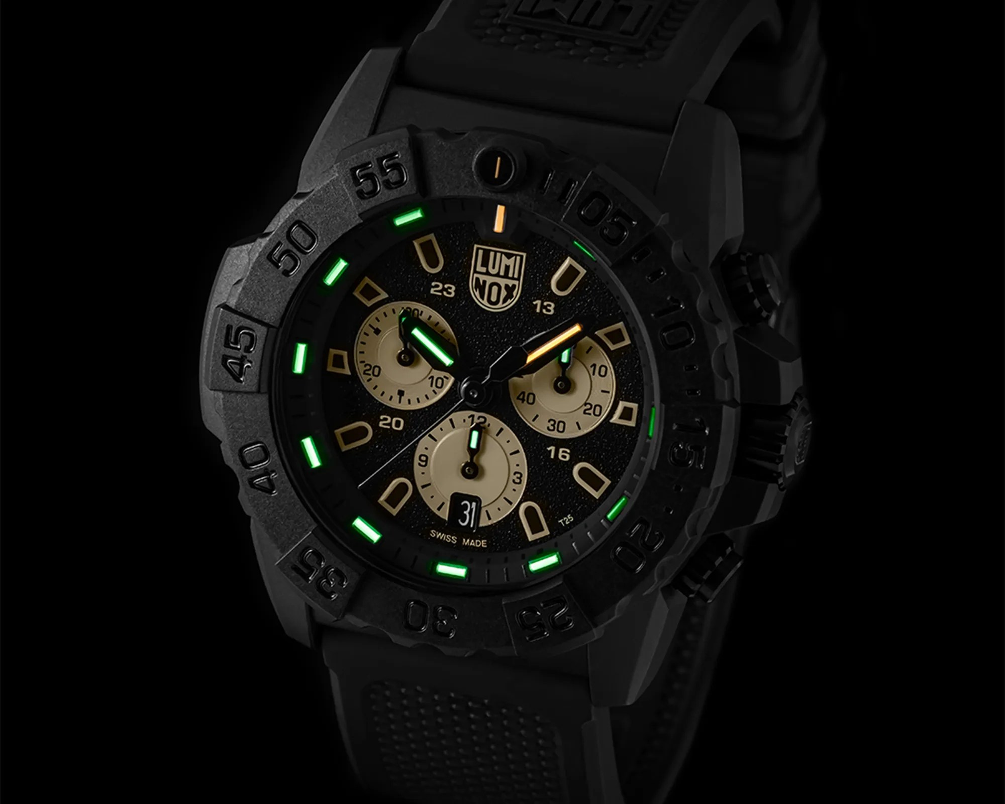 Black Luminox wristwatch with green and orange luminescent hands, beige subdials, and a textured black rubber strap.