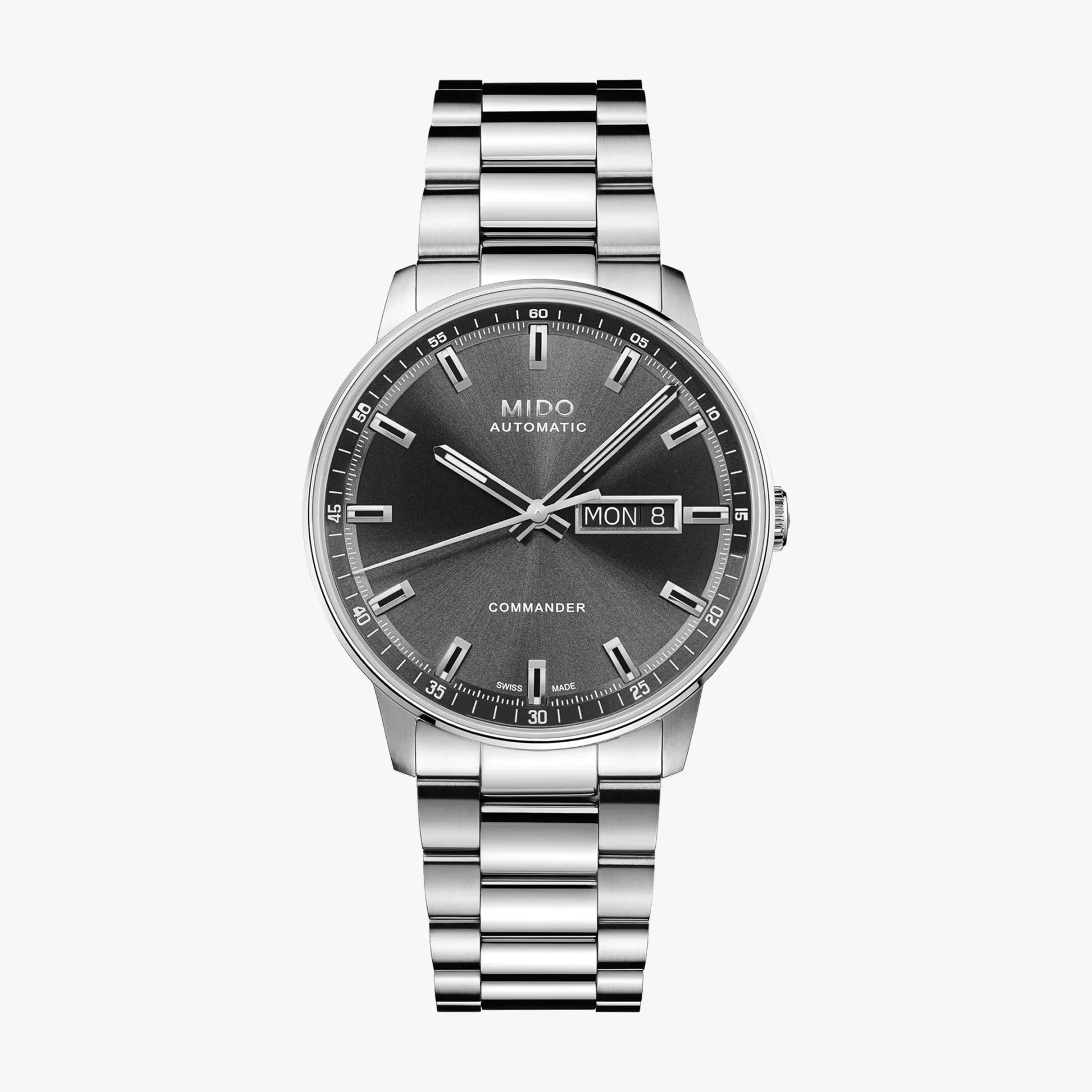 Silver stainless steel Mido Commander wristwatch with a dark gray sunburst dial and day-date display.