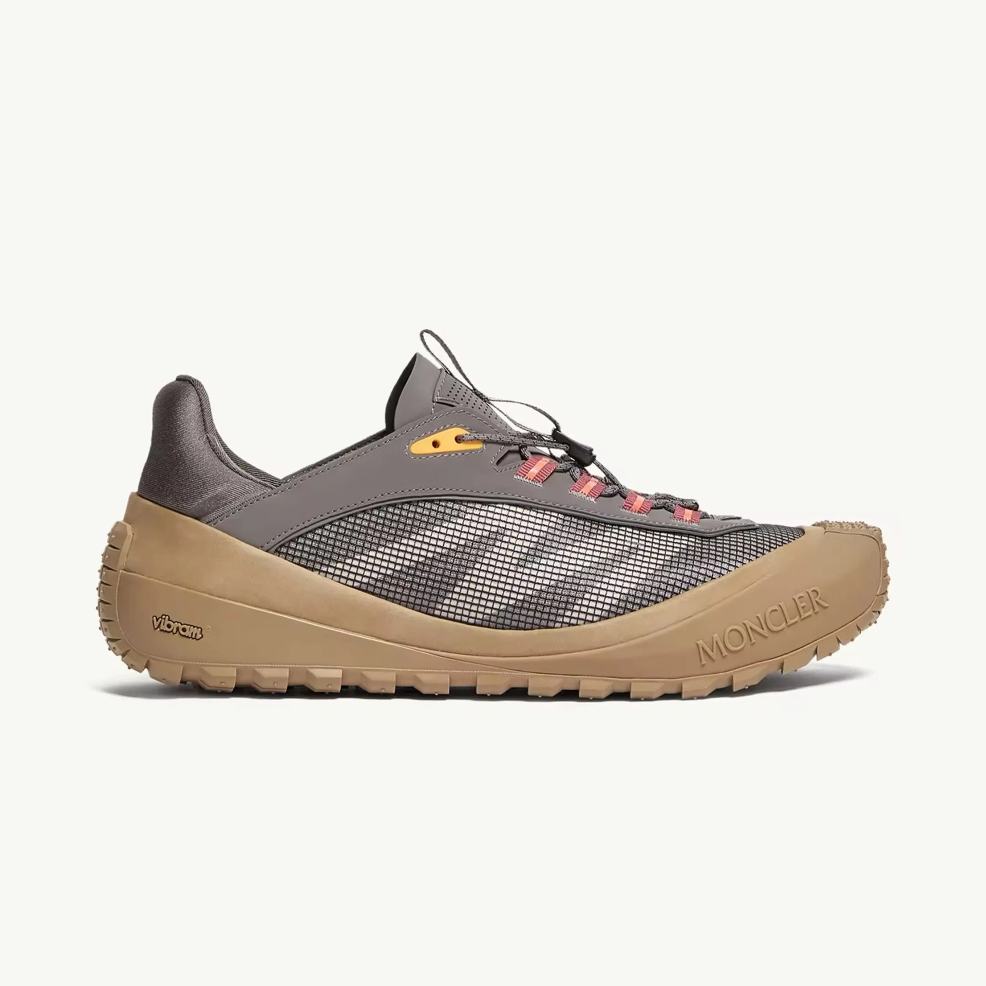Gray and tan Moncler sneaker with mesh upper and Vibram sole, featuring pink lace loops and embossed logo on the toe.