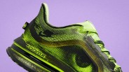 Green and black Nike ZoomX running shoe with a honeycomb pattern on a purple background.