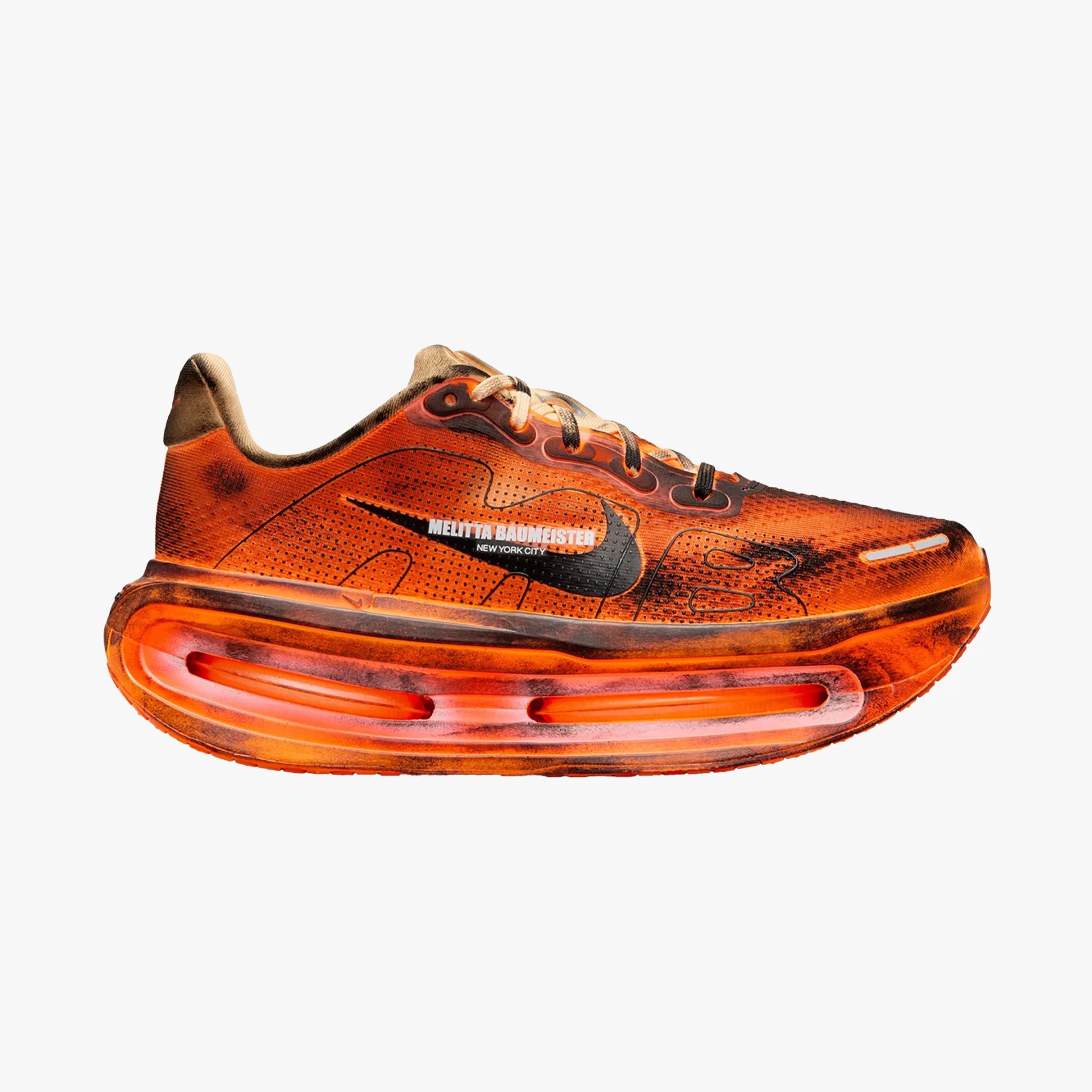 Orange and black Nike sneaker with "Melitta Baumeister New York City" text and thick cushioned sole.