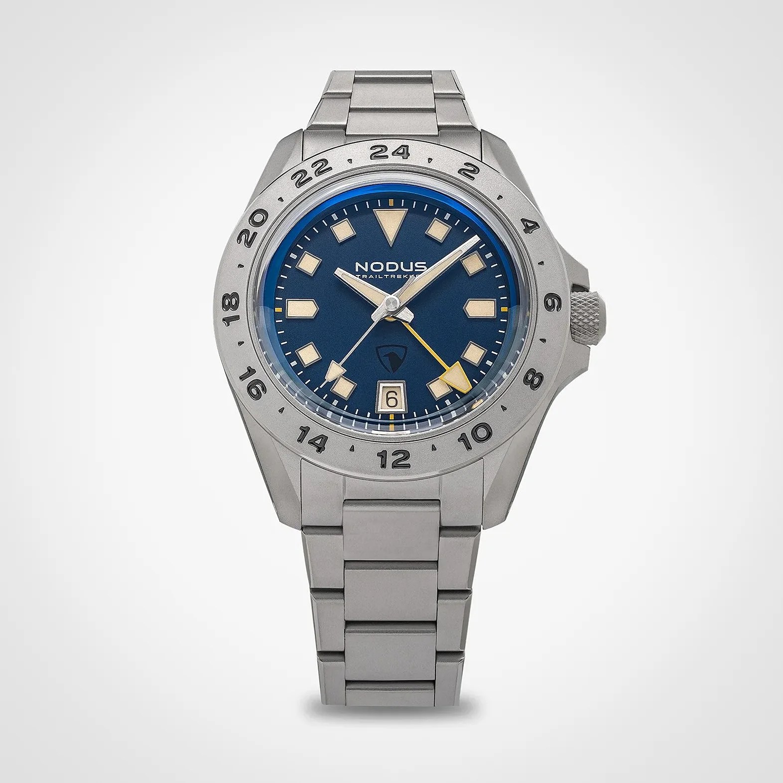 Silver metal wristwatch with blue dial, beige hour markers, date window at 6 o'clock, and 24-hour bezel.