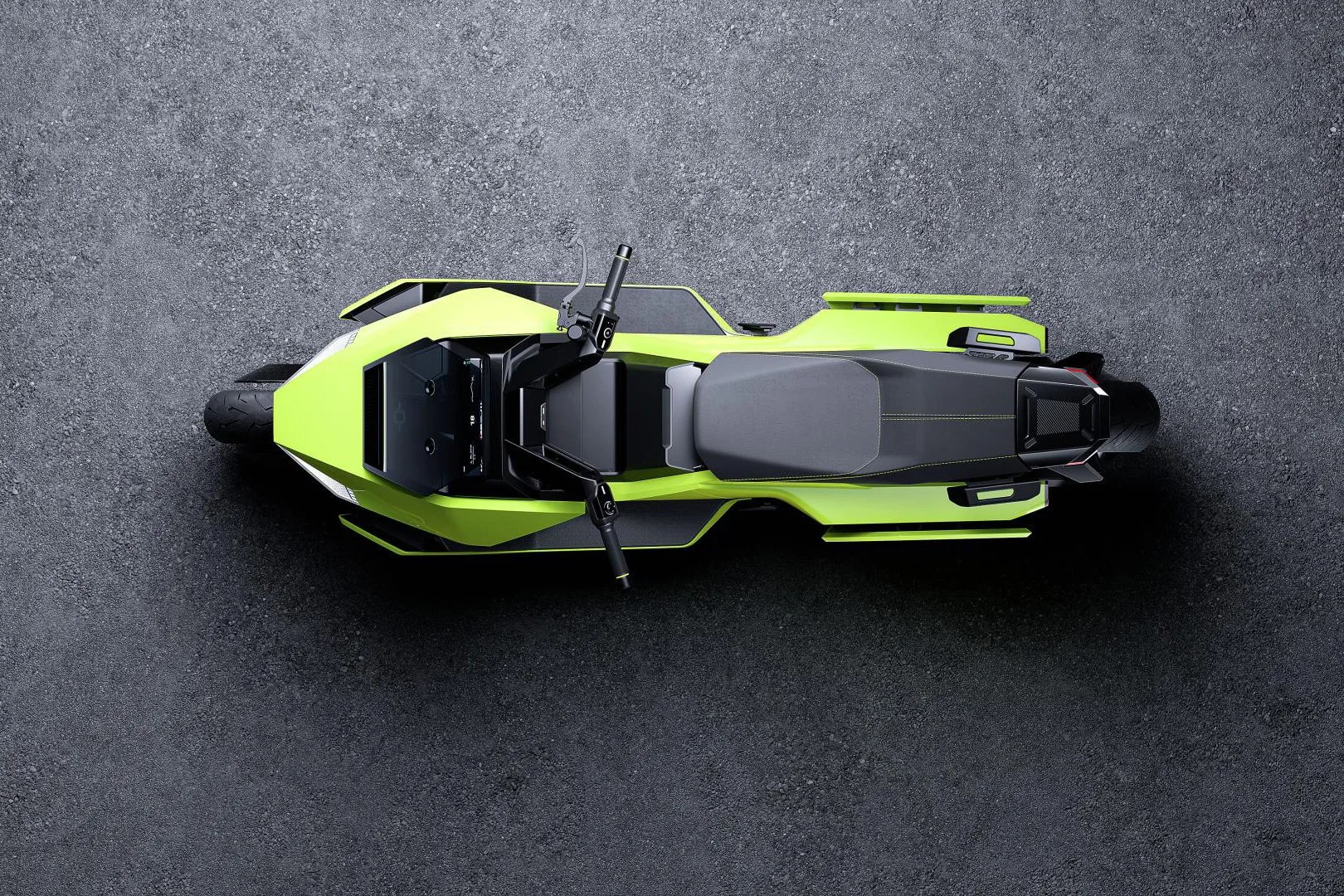 Top view of a neon green and black electric motorcycle on a textured gray surface.