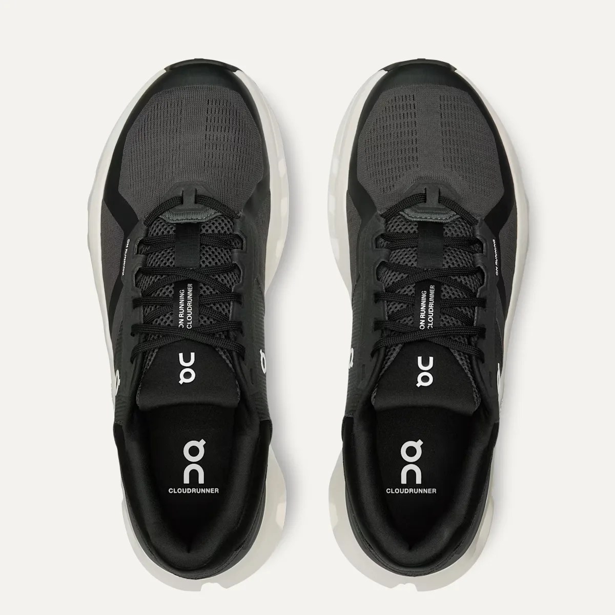 Pair of black On Running Cloudrunner sneakers with white soles viewed from above.