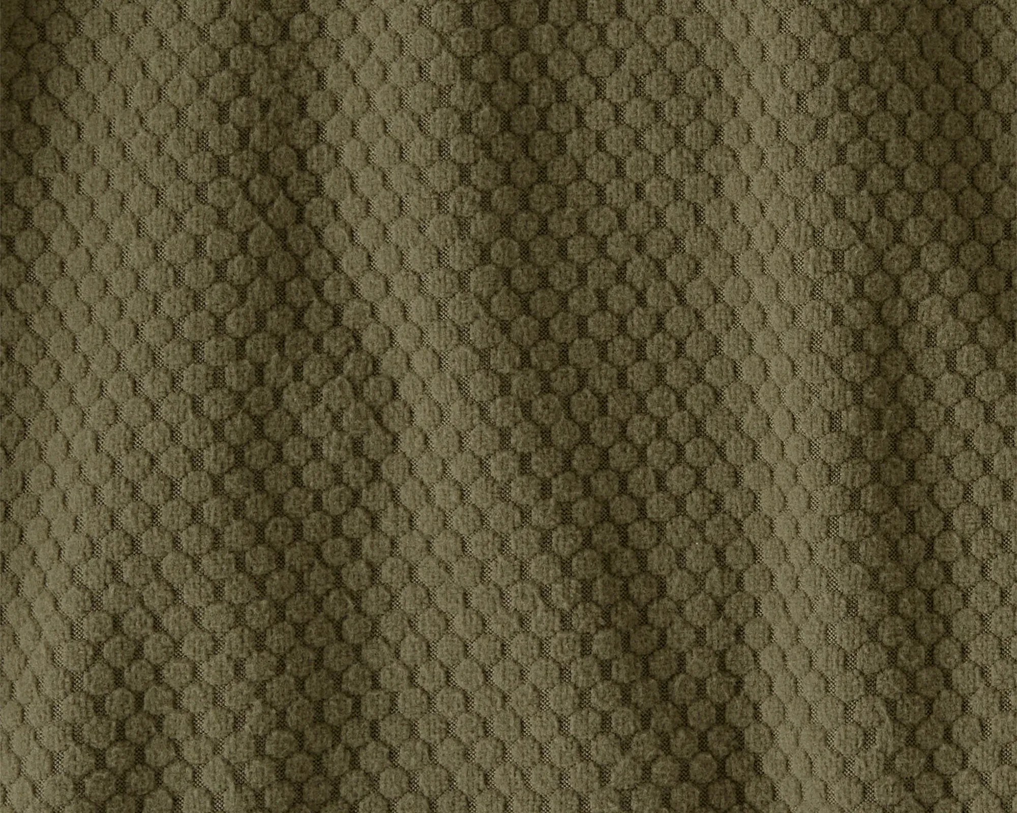 Olive green fabric with a textured pattern of small raised circles.