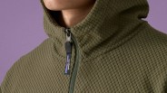 Olive-green textured fleece jacket with a hood and a Patagonia-branded zipper pull.