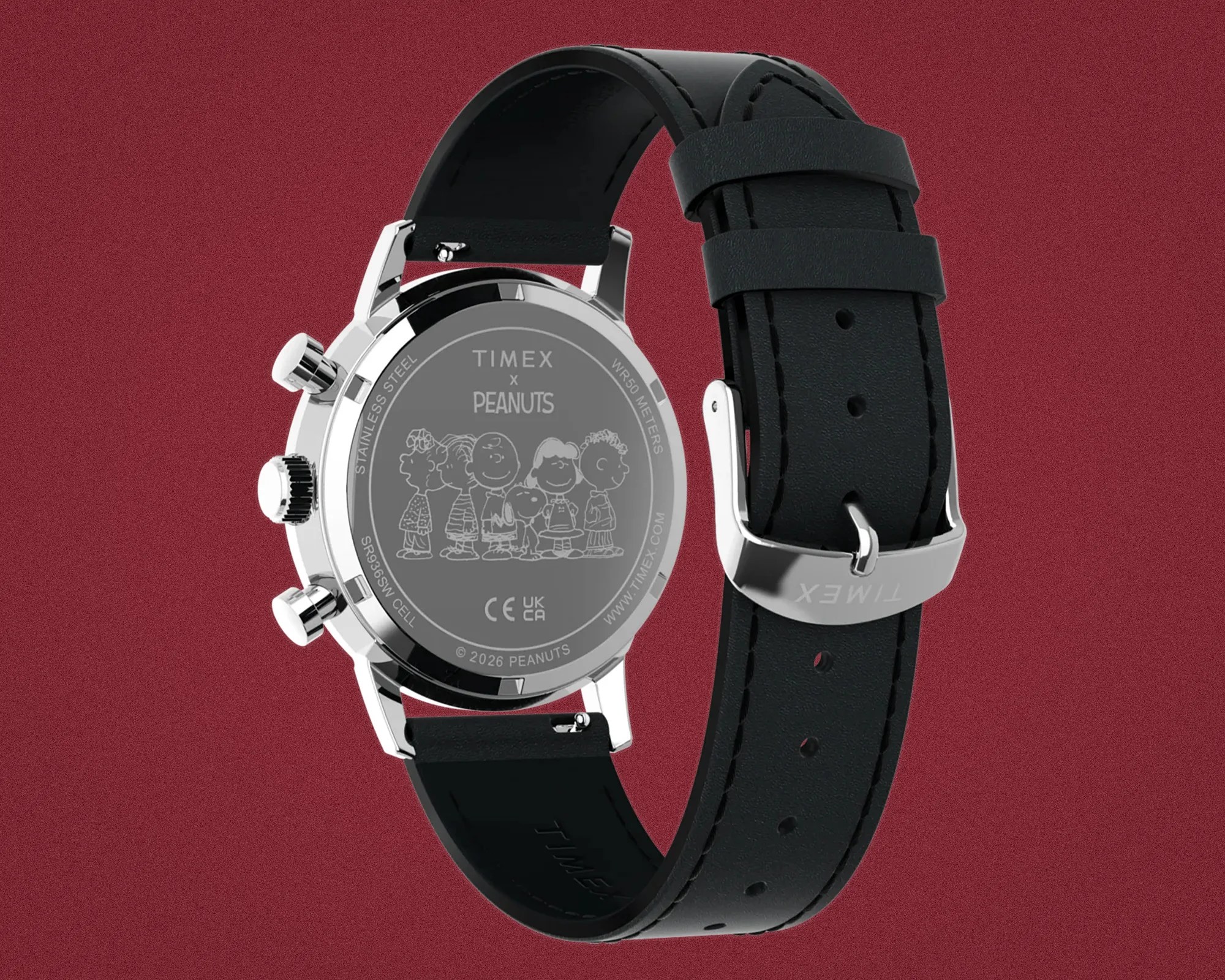 Back of a Timex watch with black leather strap and engraved Peanuts characters on stainless steel case.
