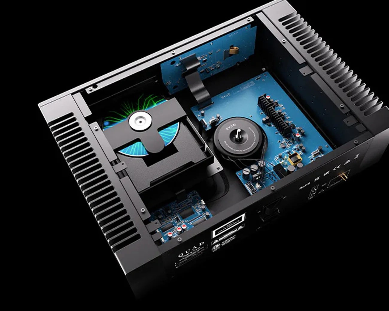 Open black audio amplifier chassis showing blue circuit boards, a toroidal transformer, and a CD drive with a disc inside.