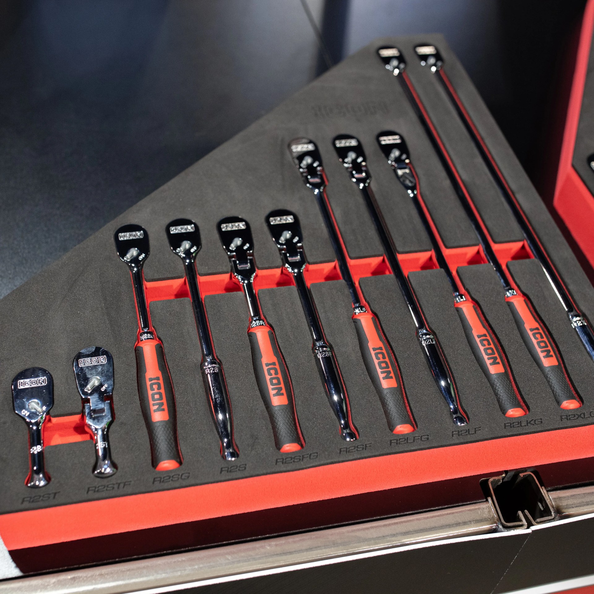 Set of chrome and black ratchet wrenches with red and black handles neatly arranged in a black and red foam tool organizer.