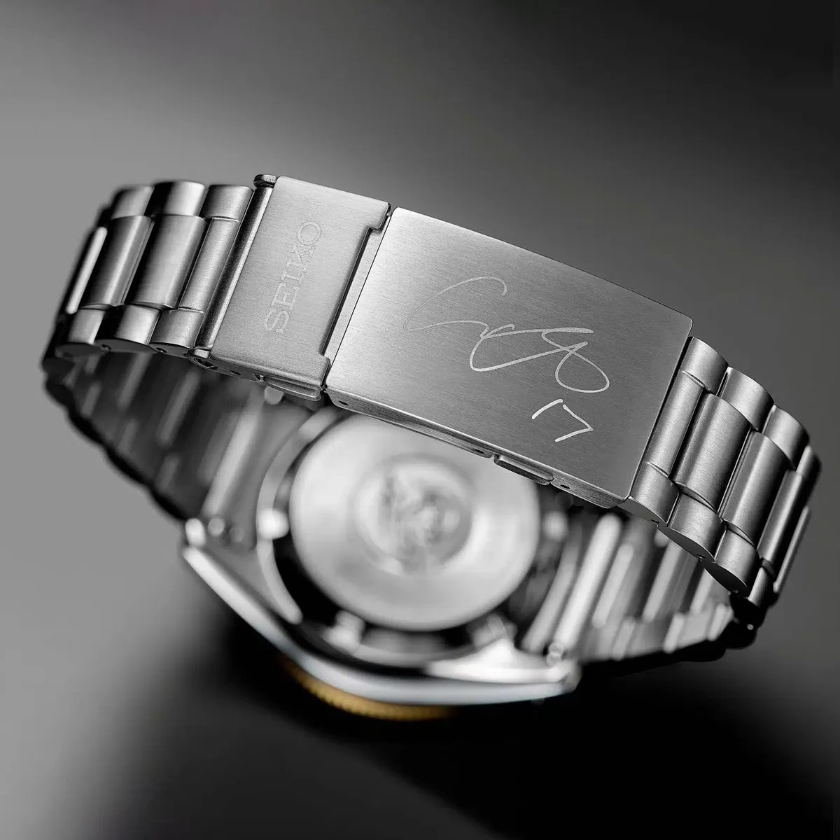 Brushed stainless steel Seiko watch bracelet with signed clasp and engraved "17" on the clasp.