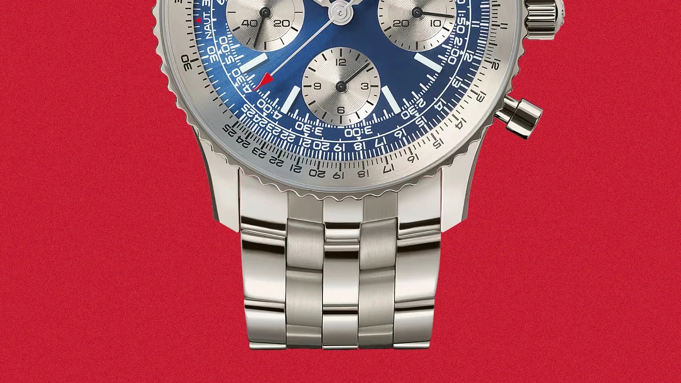 Close-up of a silver metal watch bracelet with polished and brushed links attached to a blue chronograph watch face.