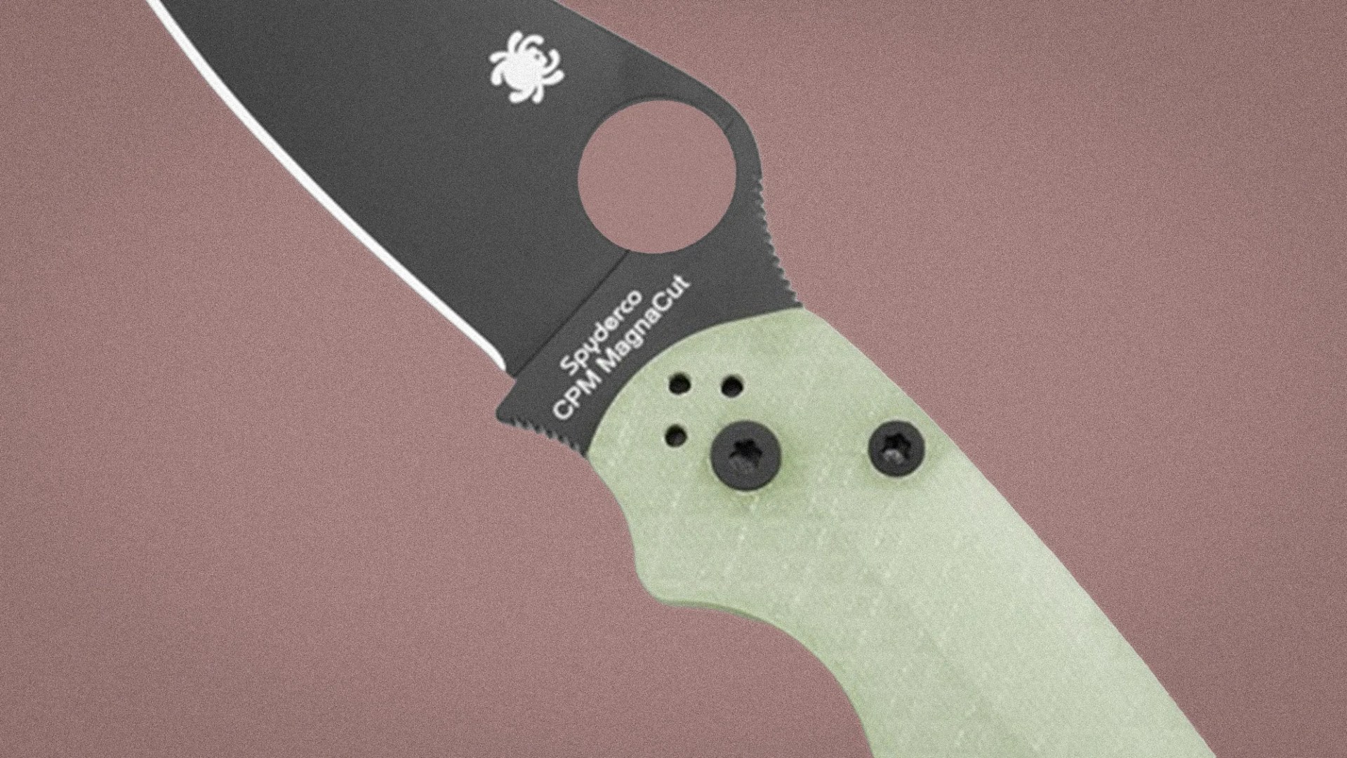 Close-up of a Spyderco folding knife blade with CPM MagnaCut steel and a light green textured handle.