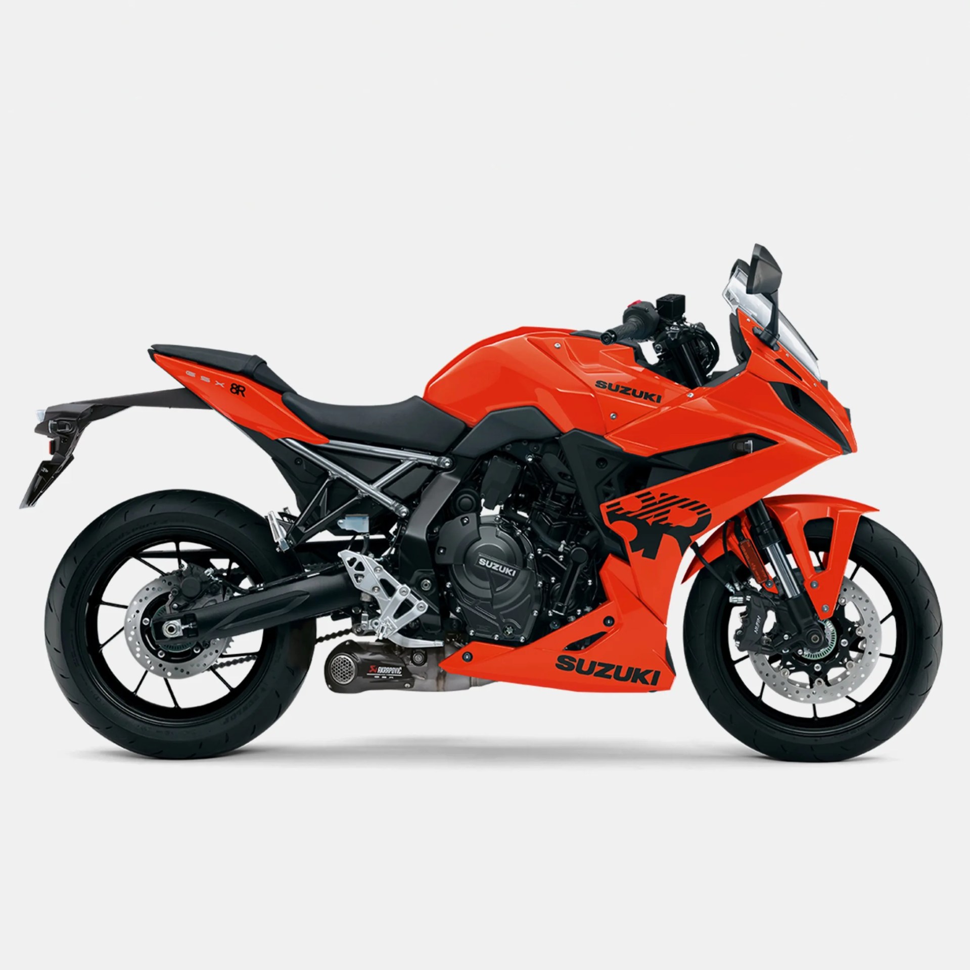 Bright orange Suzuki sport motorcycle with black accents and Akrapovic exhaust, shown from the right side.