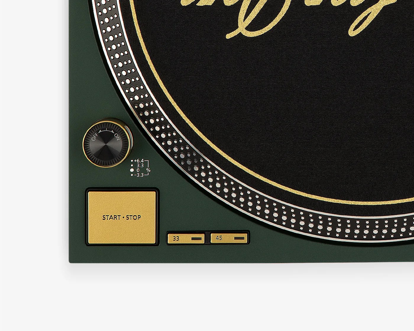 Close-up of a dark green turntable corner with gold start/stop button, speed selectors, and a black dial with gold trim.